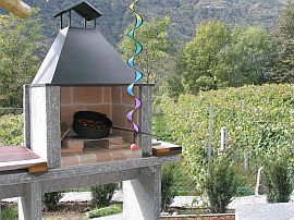 Stone pergola & grill looking into a large vineyard